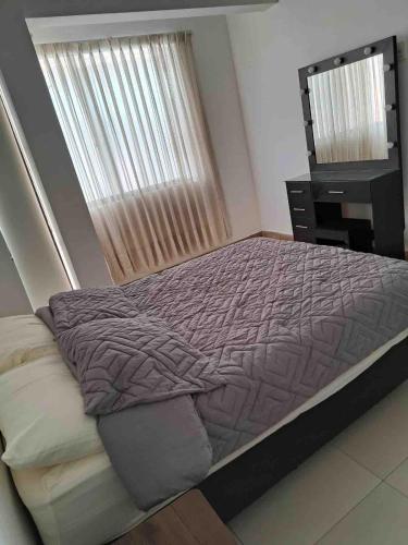 a bedroom with a bed and a dresser and a window at Beautiful house downtown in Tarija