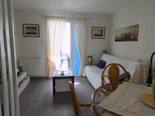 un salon avec un lit et une table dans l'établissement Charmante maison à 400m de la plage des Demoiselles avec véranda et cour close - FR-1-323-367, à Saint-Hilaire-de-Riez