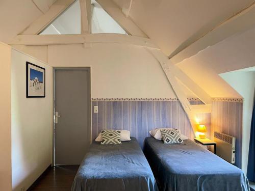 two beds in a room with a roof at Maison 8 min du Zoo de Beauval, jardin, cheminée, tout inclus, proche Châteaux de la Loire - FR-1-491-429 in Châteauvieux