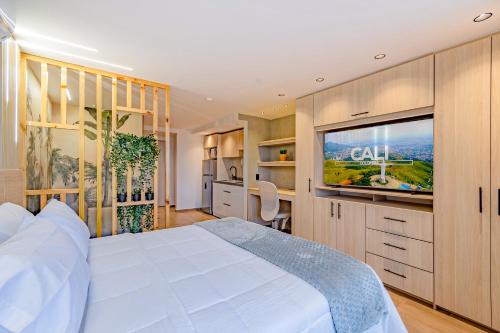 a bedroom with a white bed and a flat screen tv at Edificio Habitare Cristales Cali 2 in Cali
