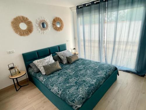 - un lit bleu dans une chambre avec fenêtre dans l'établissement Villa Rénovée 3 Chambres, Proche Plage avec WiFi, Ménage et Linge Inclus - FR-1-323-507, à Saint-Hilaire-de-Riez