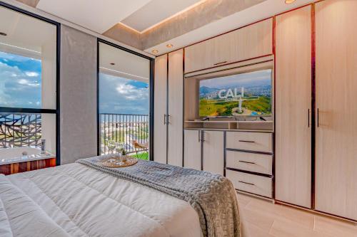 a bedroom with a bed and a balcony with a sink at Edificio Habitare Cristales Cali 2 in Cali