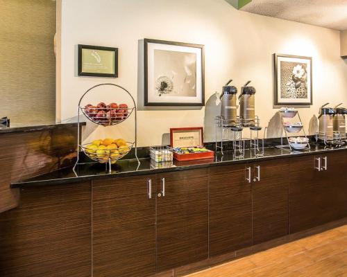 a counter with two baskets of fruit on it at Sleep Inn South Joplin in Joplin