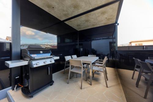 a kitchen with a table and a stove and chairs at Ocean Bridge Awaji in Awaji