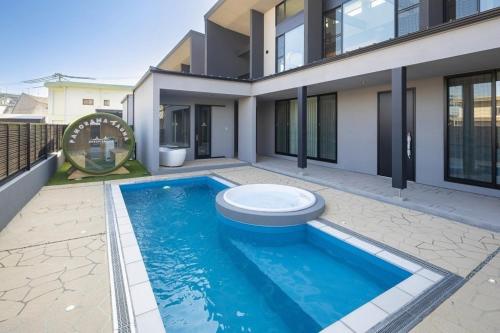 a swimming pool in front of a house at Ocean Bridge Awaji in Awaji