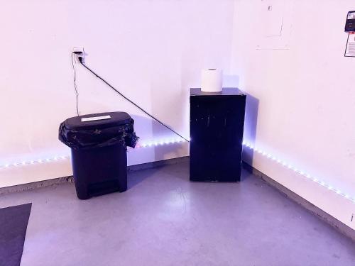 a room with a trash can and a roll of toilet paper at King Suite - Game Room - Gym - Private Bath - Hot Tub in Ellenwood