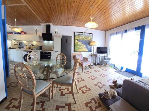 un salon avec une table et des chaises et une cuisine dans l'établissement Maison calme proche plage, animaux acceptés - FR-1-476-234, à La Faute-sur-Mer