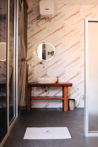 a bathroom with a sink and a mirror on a wall at Aqua Dive resort Amed in Amed