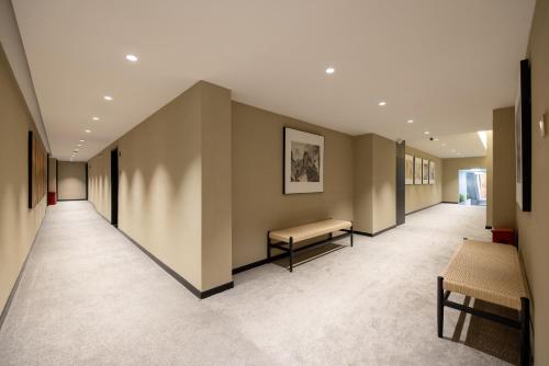 a hallway with a bench in the middle of a building at Beijing Tangfu Nanluoguxiang Tian an Men Lama Temple San Li Tun Snack Street Hotel,Free Laundry Dry Service and Free Afternoon Tea &professional Free Tour Ticket Service with English Speaking Staff in Beijing