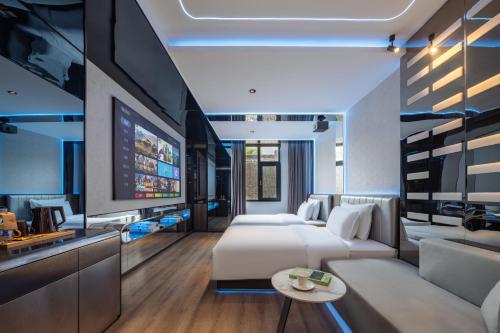 a hotel room with a bed and a tv at Xi'an Bell and Drum Tower Yongning Gate Lanfeng Hotel in Xi'an