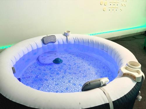 a small swimming pool in a room at King Suite - Private Bath - Gym - Hot Tub - Game Room in Ellenwood