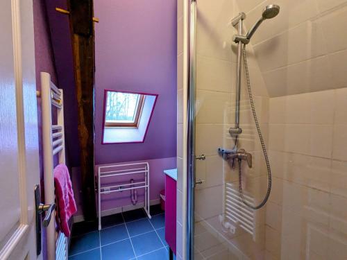a bathroom with purple walls and a shower at Gîte paisible près de l'Indre, proche de la nature, 2 chambres - FR-1-591-750 in Buzançais