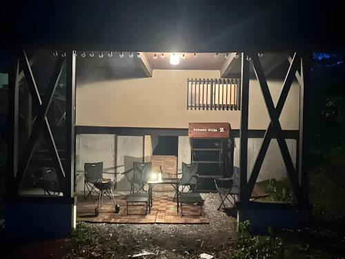 a group of chairs sitting on a patio at night at Private Villa Z in Tsumagoi