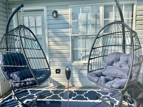two swings on the front porch of a house at King Suite - Half Bath - Gym - Game Room - Hot Tub in Ellenwood