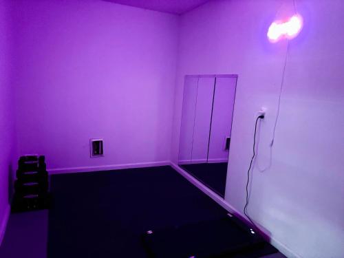 a room with a purple room with a door at Queen Suite - Gym - Game Room - Hot Tub in Ellenwood