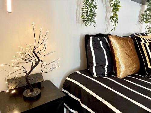 a bedroom with a bed and a table with a plant at Queen Suite - Gym - Game Room - Hot Tub in Ellenwood