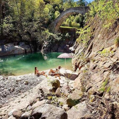 two people laying in the water in a river at Holiday home in Ceppo Morelli - Piemont 52109 in Ceppo Morelli
