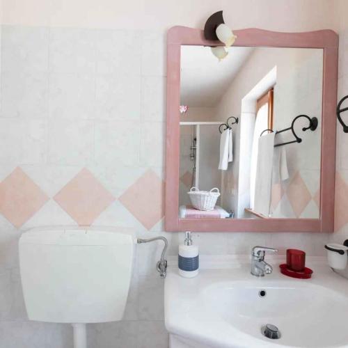 a bathroom with a sink and a mirror at Holiday home in Ceppo Morelli - Piemont 52109 in Ceppo Morelli