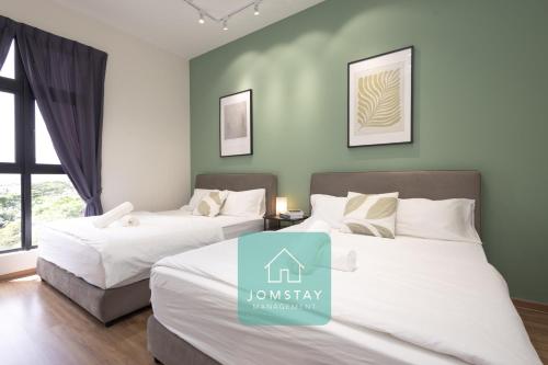 Ένα ή περισσότερα κρεβάτια σε δωμάτιο στο Jomstay The Cove Ipoh Hillside Residence