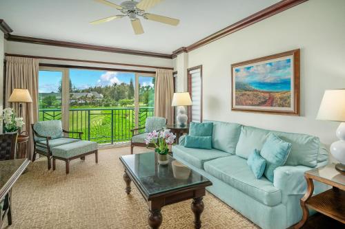 a living room with a couch and a table at Waipouli Beach Resort and Spa Kauai by OUTRIGGER in Kapaa