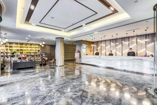 a lobby with a bar and a restaurant at Atour Hotel Harbin Nangang District Government in Harbin