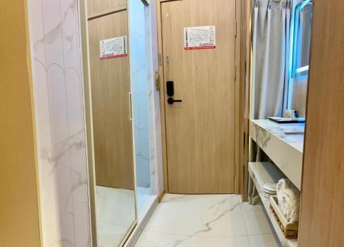 a bathroom with a shower and a glass door at 上海璞逸酒店-豫园 新天地 老西门地铁站店 in Shanghai