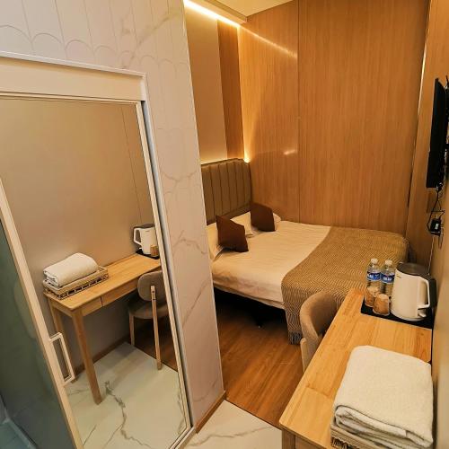 a small room with a bed and a mirror at 上海璞逸酒店-豫园 新天地 老西门地铁站店 in Shanghai