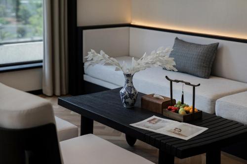a living room with a vase on a coffee table at Non Hills in Anji
