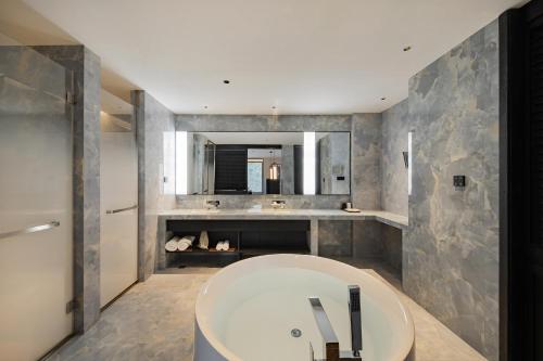 a bathroom with a large tub and a sink at Non Hills in Anji