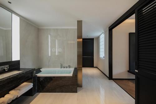 a bathroom with a tub and a sink at Non Hills in Anji