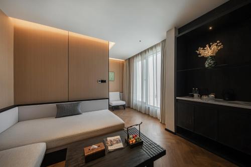 a living room with a bed and a table at Non Hills in Anji