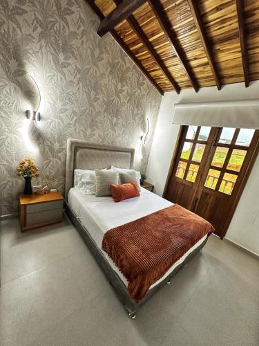 a bedroom with a bed with a brown blanket at Curiti Luxury House in Curití