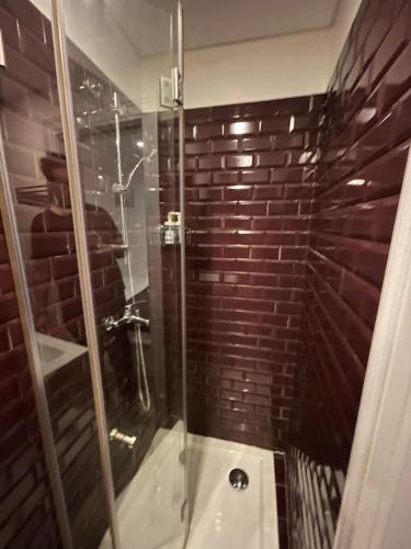 a bathroom with a shower with a glass door at Suite - Centro histórico Mouraria in Lisbon