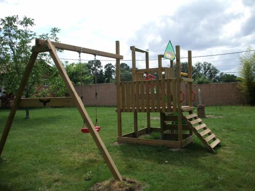 a wooden playground in a yard at Posada Tresmentiras in Aldeanueva del Camino