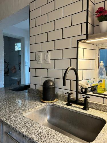 a kitchen counter with a sink in a kitchen at Casita Amarillo Sol con Casa de Te, Pileta y Parrilla in Yerba Buena