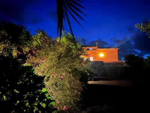 a house with a light on it at night at A Casa Amarela in Capelas