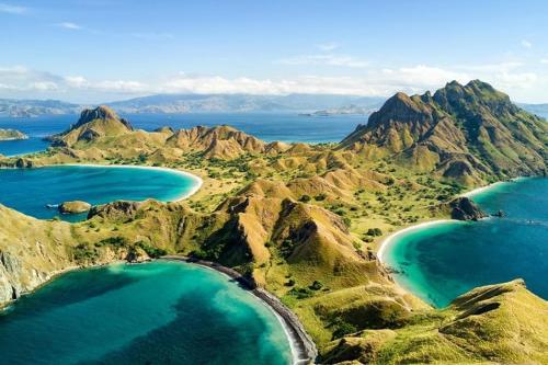 an aerial view of a mountain range with turquoise water at 4D3N CRUISE Lombok-Komodo-Flores in Mangsit