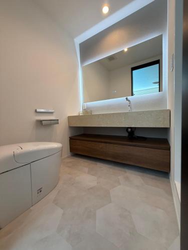 Cama o camas de una habitación en 御宿ガーデンヴィラ