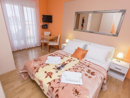 a bedroom with a large bed and a mirror at Villa Valentina in Zadar