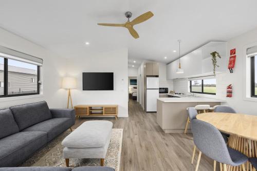 a living room with a couch and a table at Swan Bay Holiday Park in Queenscliff