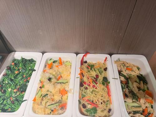 four plastic trays of different types of food at Atour Light Harbin Central Street in Harbin