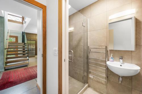 a bathroom with a sink and a shower at Macpherson Street, Wanaka in Wanaka