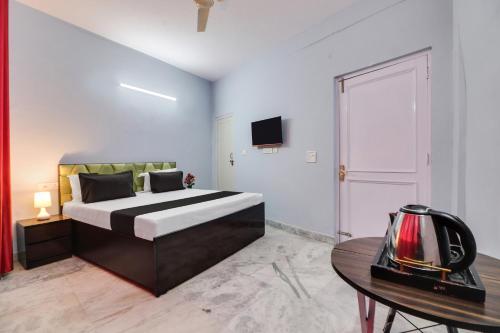 a bedroom with a large bed and a table at Hotel O Blue moon in New Delhi