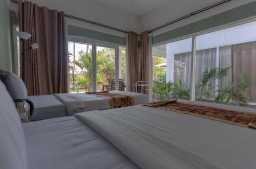 Ένα ή περισσότερα κρεβάτια σε δωμάτιο στο Wave Inn - beach house