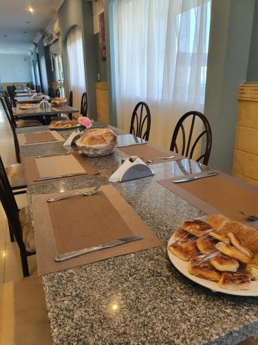 a row of tables with plates of food on them at Relaxed families sea view master bedroom in Raʼs Matarma
