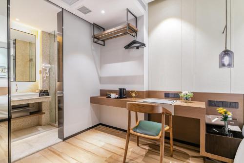 a bathroom with a desk and a sink in a room at Huiju Hotel -Shamian Xidi Pier Night Cruise on the Pearl River branch--Canton Fair free shuttle bus included Breakfast in Guangzhou