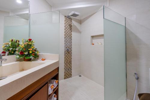 a bathroom with a shower and a sink at Dewi Sri Hotel in Legian