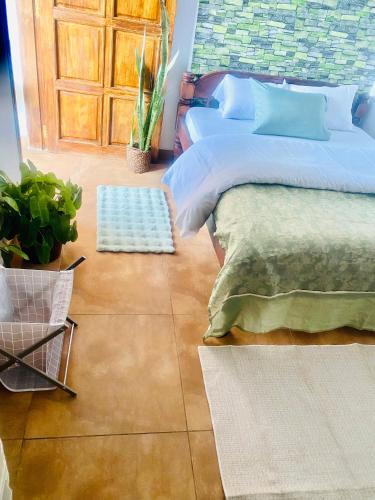 a bedroom with a bed and a door at Shikos Place in Watamu