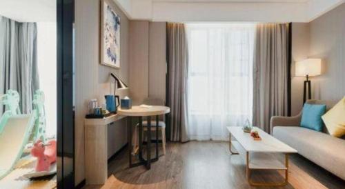 a living room with a couch and a table at Echarm Hotel Nanning the MixC Dongmeng Business District in Nanning