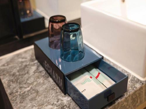 a box with two vases in it on a counter at Echarm Hotel Nanning the MixC Dongmeng Business District in Nanning